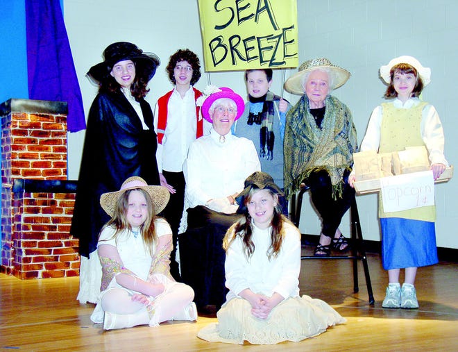 In a scene from “The Pageant for St. Salome,” Savannah Carpenter, front, left, and Mary Grace Jacobs, Stephanie Kanis, standing, left, Donna Torpey, Peggy Gillen and Emma Claire Draper, and Eric Kanis, back, left, and Evan Siebert, portray Sea breeze neighbors. Torpey (in pink hat) plays Salome Boucher, who donated, with her husband, for the first St. Salome’s Church.