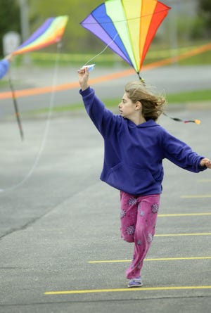 Emily Mercier, 10, of Framingham flies a kite during the Flutie Foundation and the Autism Alliance of MetroWest's Kite Day at Bose Mountain.