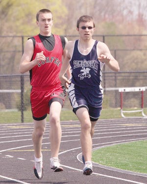 PHOTO BY BOB ALMEIDA
neck and neck: Nick Blake (R) leads Durfee's Ryan Rezendes in the mile.