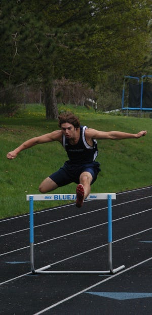Arkport’s Chris Pfaff clears a hurdle in the 400-meter event at Saturday’s John Reed Invitational hosted by Arkport Central School.