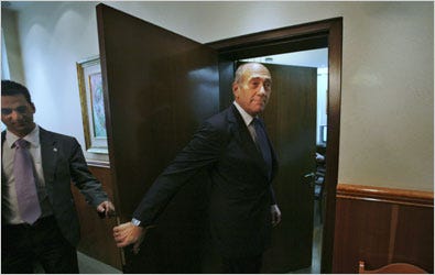 Prime Minister Ehud Olmert, right, leaving his office in Jerusalem on Sunday. Mr. Olmert is under police investigation but the accusations are covered by a strict court-imposed gag order. Some commentators in the Israeli news media have received leaks about the accusations.