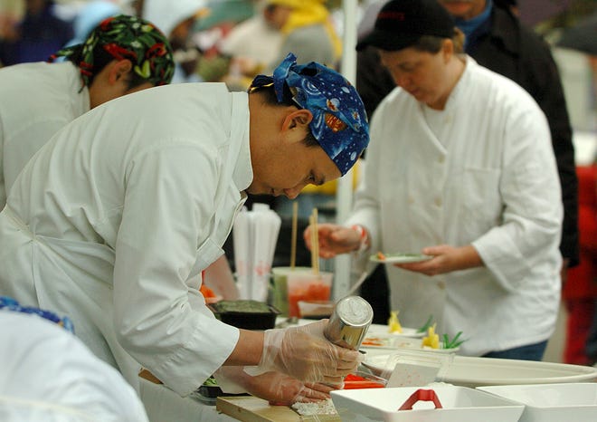 Sushi chef Sua Tom rolls sushi during the annual A Taste of Hingham on Saturday.