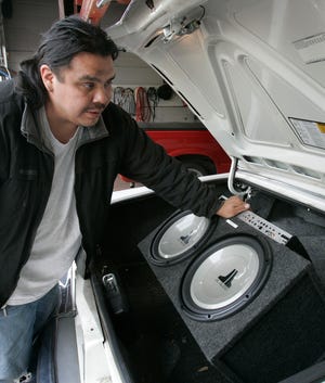 John Bent shows a sub-woofer and 1,000-watt amplifier Wednesday, April 30, 2008, that can be put in the trunk of a car at Audio Installers Inc. in Rockford.