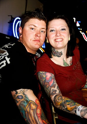 Kenny Martin, 24, and Annette Poff, 26, show their tattoo art Friday, May 2, 2008, at the Vanilla Ice concert at LT's Bar and Grill.