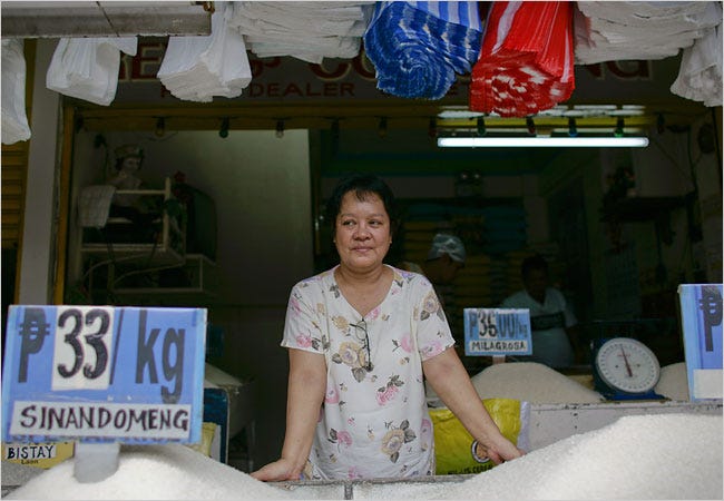A rice dealer at a market south of Manila in the Philippines, the world’s largest importer of rice.