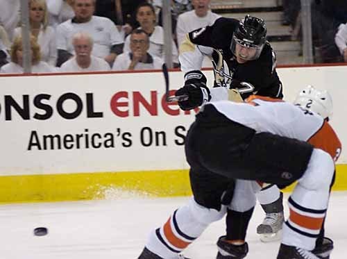 Penguins center Evgeni Malkin gets off a shot before Flyers defenseman Derian Hatcher can block it during the first period of Friday's game at Mellon Arena. (The Times/KEVIN LORENZI)