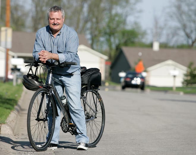 Todd Johnson rides his bike from his home off Harrison Avenue to his job at Heartland Community Church in Rockford.