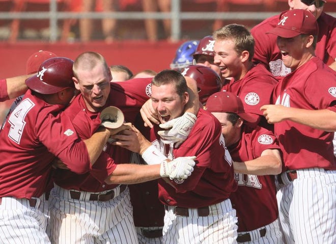 Jake Smith is mobbed at home plate after scoring the tying run in the bottom of the eighth inning.