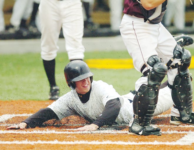 Adrian College sophomore Alex Cowart slides safely across home plate during an MIAA game against Alma last Wednesday. Cowart and the Bulldogs received an at-large bid to the NCAA tournament today.
