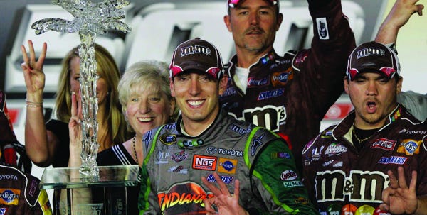 Kyle Busch holds up three fingers after winning his third Sprint Cup race of the season by taking the checkered flag in the Dodge Challenger 500 at Darlington International Raceway on Saturday.