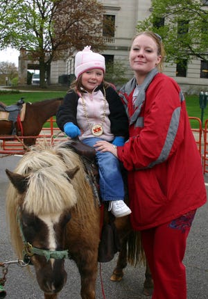 Autumn Stewart, 3, enjoys a pony ride at the Cinco de Mayo celebration in Sycamore, while her mom, Kacee Morse stands close by on Saturday, May 3, 2008.