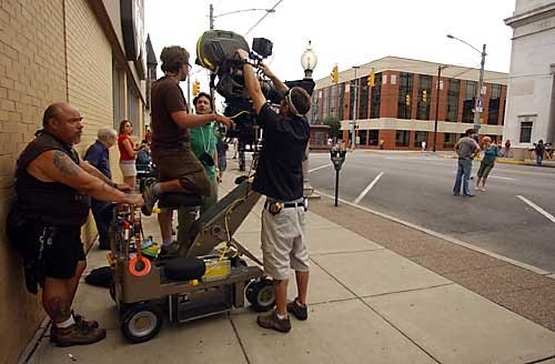 Lucy Schaly photo 8/15/05A movie called "Graduation" is being filmed on Seventh Avenue in Beaver Falls for two more days. Actors Shannon Lucio and Chris Lowell are at right. Camera crew puts on a new roll of film.