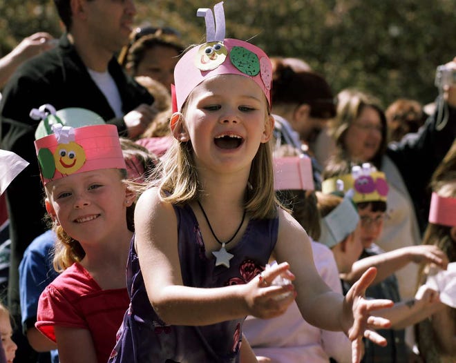 Jefferson Elementary School kindergartner Catherine Doyle, 6, cheers as she and her classmates release butterflies Wednesday during an event in which the children sang butterfly songs, read butterfly poems and shared butterfly facts.