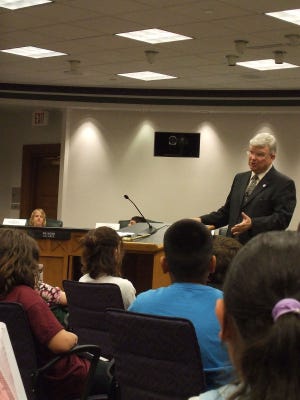 Holland Mayor Al McGeehan speaks to fifth-graders from East K-8 school Thursday afternoon. McGeehan and City Manager Soren Wolff helped fifth-graders elected by their classmates to conduct a mock city council session at city hall.