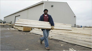 Kansas re-entry parolee Lonnie Kemps works in a lumber yard on Thursday in Wichita, Kan.
