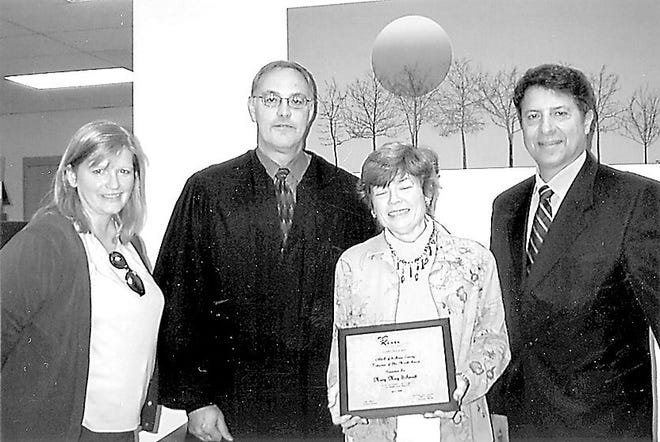 Sullivan County’s Court-Appointed Special Advocates has named Mary May Schmidt, holding plaque, as Volunteer of the Month for April. With Schmidt are Claire Sullivan, president of Sullivan County CASA, Judge Mark Meddaugh and Sullivan County legislator Ron Hiatt, far right, member of the New York state CASA board of directors.