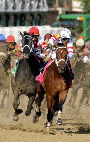 Big Brown, right, and Eigh Belles, left, round the far turn, etering the stretch during the 134th Kentucky Derby on May 3 at Churchill Downs in Louisville, Ky. Eight Belles fractured both her front ankles after the race and had to be euthanized.