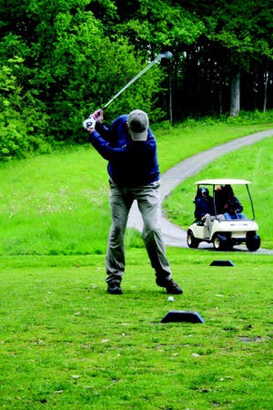 Gordon Kircher from the Office Specialist team winds up for a big drive at Monday’s Chamber golf outing. The event was not cancelled despite nasty weather.