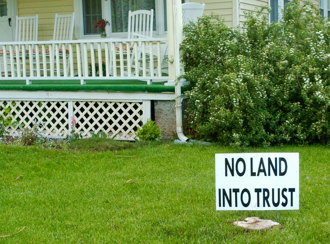 A sign stands in a yard, Tuesday, May 20, 2008, in Oneida. The U.S. Department of Interior's decision Tuesday will put 13,004 acres of Oneida Nation land into trust. Any land that goes into trust would be exempt from state and federal taxes and regulations.