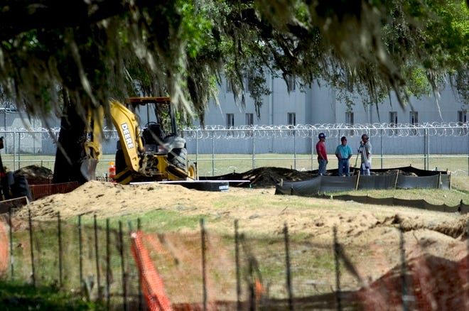 A crew surveys the land near the Marion County Jail where pipes will be laid for the new Marion County Emergency Operations Center in Ocala. The new operations center should be ready by 2009's hurricane season.