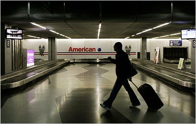 A traveler walked through the American Airlines baggage claim area at O'Hare International Airport in Chicago in April.