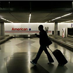 A traveler walked through the American Airlines baggage claim area at O'Hare International Airport in Chicago in April.