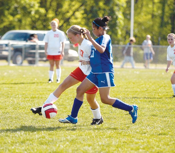 Tecumseh’s Ashton Lacelle tries to get past Adrian’s Mary Ann Martinez during Thursday’s SEC contest.