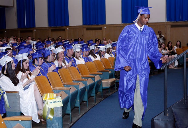 Dominique Jean-Pierre takes the big walk to the stage to receive the Principal's Recognition Award at Marian High's graduation in Framingham Friday night.