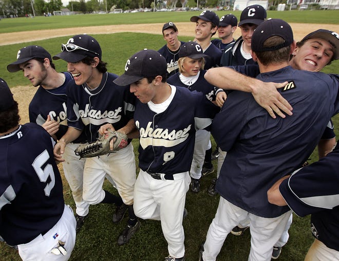 Cohasset's Dave Snowdale embraces Brian Hill while the rest of the Skippers celebrate their South Shore League title on the field following their 8-4 win over Carver. It is Cohasset's first title in 49 years. They tied Abington for first place in the league with the victory completing a last place to first place turnaround.