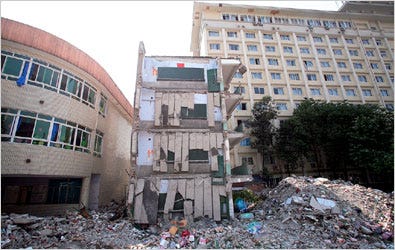 UNEQUAL DAMAGE. Xinjian Primary School in Dujiangyan was destroyed, while a kindergarten, at left, and a hotel were barely damaged.