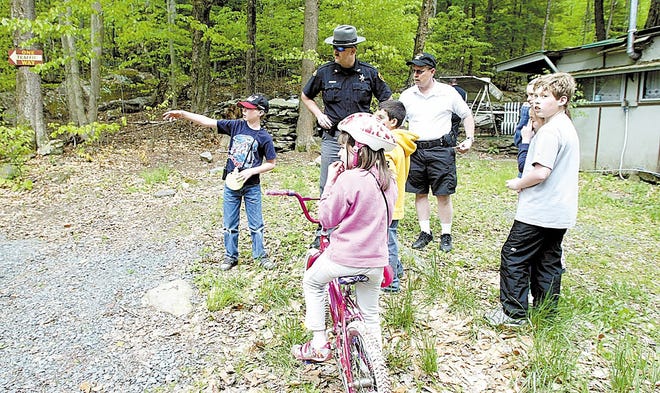Sullivan County sheriff’s deputies interview children at the Swinging Bridge Campground in Mongaup Valley after a 3-year-old boy disappeared Saturday afternoon.