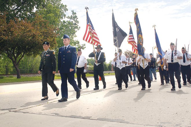 U.S. Army Maj. Audrey Brown and her brother, Airman 1st Class Justin Brown of the U.S. Air Force, both of Blissfield, lead the Memorial Day parade on Monday in Blissfield.