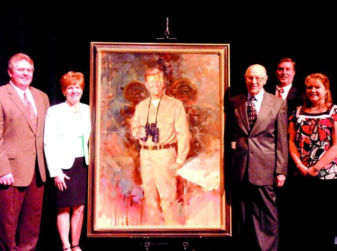 A portrait of the late Rear Adm. Eugene Bennett Fluckey, a 1930 graduate of Mercersburg Academy, was unveiled during a ceremony Monday afternoon in Mercersburg Academy’s Burgin Center for the Arts. Several members of Fluckey’s family members and crew men attended the ceremony. From left: grandson Tom Bove of Leesburg, Va., granddaughter Gail Fritsch of Crofton, Md., crew member John Lehman of Chambersburg, Gail’s husband, Matthew Fritsch, and John’s wife, Pamela Lehman.