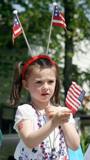 Breena Kelly, 4, of Tewksbury, is decked out in flags for the Tewksbury Memorial Day parade.