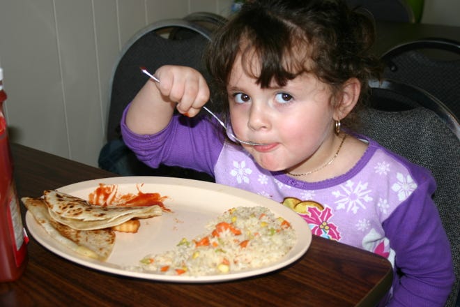 Paula Medina, 3, eats quesadillas at Isla del Mar in Rockford. The restaurant offers a children’s menu.