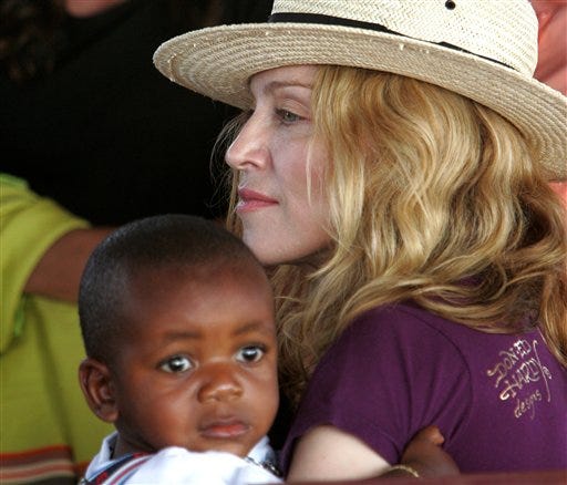 In this April 19, 2007 file photo, Madonna holds David Banda in her arms in Mchinji, Malawi. A Malawi judge has approved Madonna's adoption of a Malawian boy she found in an orphanage in 2006. Madonna was not in court for Wednesday's, May 28, 2008, ruling. The pop star and her husband, film director Guy Ritchie, have been caring for the boy, David Banda, in London. David turns 3 in November.