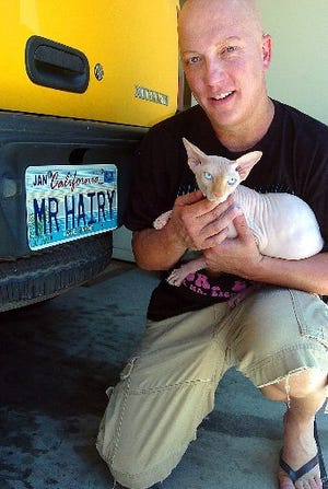 Redwood City, Calif., resident Matt Kelley is shown with his hairless cat Harry at their home. Kelley was instrumental to the introduction of House Resolution 5936, which would require Medicaid to provide hair prostheses for people affected by alopecia areata, a rare disease in which a person loses all of his or her body hair.