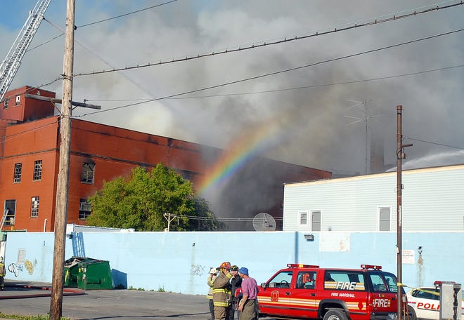 A rainbow comes out of the smoke as firefighters from Utica and surrounding communities battle a fire, Thursday, May 29, 2008 at the F.X. Matt Brewery in Utica. The fire broke out around 5 p.m. as hundreds were gathering for the first installment of the annual Saranac Thursday party outside the brewery.