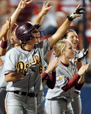 Arizona State’s Renee Welty (6) celebrates with teammates after scoring in the seventh inning against Alabama in the Women’s College World Series in Oklahoma City, Thursday. Arizona State won, 3-1.