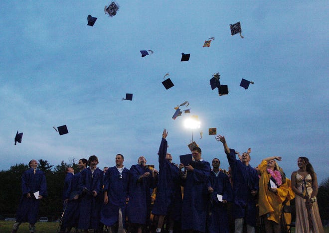 Graduates toss their mortarboards into the air at the conclusion of Friday night's Littleton High School 2008 Commencement Ceremony.