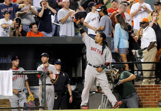 Boston Red Sox's Manny Ramirez acknowledges fans after hitting his 500th career home run in the seventh inning of a baseball game against the Baltimore Orioles Saturday night at Oriole Park at Camden Yards in Baltimore.