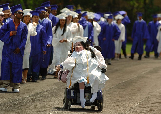 Kelly Martin makes her way around the track with her Randolph High School classmates before the commencement of graduation ceremonies.