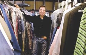 CHIEFTAIN PHOTOS/JOHN JAQUES Bret Bezona stands among some clothes at his dry-cleaning store on North Elizabeth Street. He has owned and operated Dundee Cleaners since 1980.