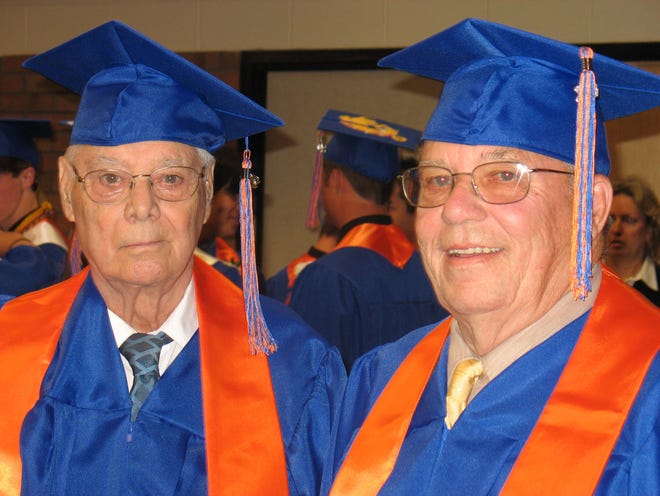 James Roberts, 83, left, and Tom Kelley, 76, receive their honorary diplomas at Saugatuck High School’s graduation ceremony. Both men left high school to serve in the military.