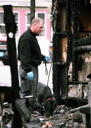 A member of the Fire Marshall's office and his dog search for the source of a fire at 6 Bow St. in Halifax.