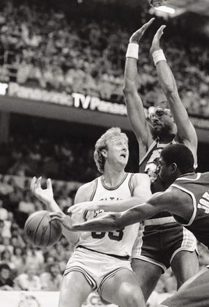 MIKE KULLEN/The Associated Press
The Celtics-Lakers rivalry of the 80s was typified by the competition between Celtics forward Larry Bird and Lakers forward Magic Johnson. In the background is Lakers center Kareem Abdul-Jabbar.