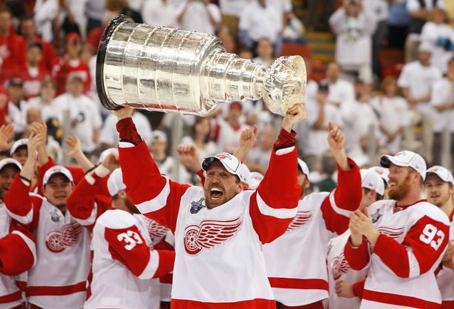 Detroit Red Wings' Dallas Drake hoists the Stanley Cup after defeating the Pittsburgh Penguins 3-2 in Game 6 of the NHL Stanley Cup hockey finals, Wednesday.