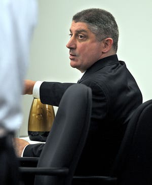 James Brescia, who is charged with hiring a hit man to kill his estranged wife's boyfriend in a Newton parking garage, appears in Middlesex Superior Court yesterday for opening arguments in his murder trial.