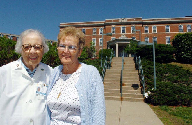 Dorothy L. Miller, 86, of Waterford, left, and Madelyn Lyman, 77, of Uncasville, former nurses at The William W. Backus Hosptial in Norwich, used to live in the former Nurses Residence behind them. They will help celebrate the 100th anniversary of The William W. Backus Hospital School of Nursing Alumnae Association on Sunday.