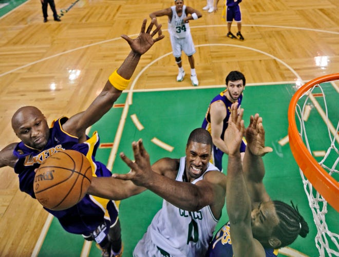 Boston Celtics' Leon Powe shoots against Los Angeles Lakers' Lamar Odom, left, and Ronny Turiaf during the first half of Game 2 of the NBA basketball finals Sunday in Boston.